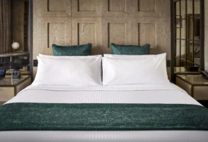 KOHLER LODGE Terrace Suite Queen bed with green shams and duvet